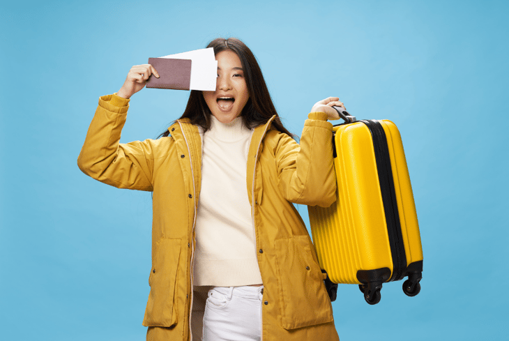 girl with plane ticket and suitcase