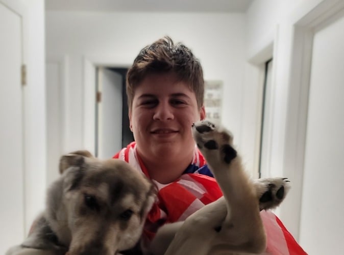 Teenage boy holding a large puppy