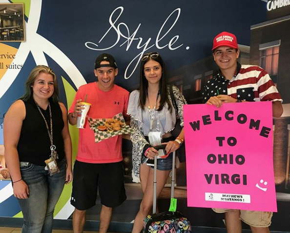 family and exchange student at airport
