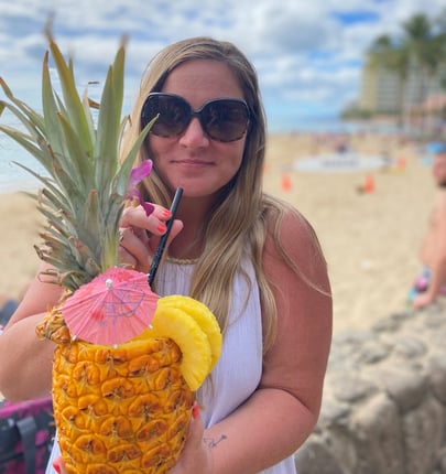 woman drinking from pineapple