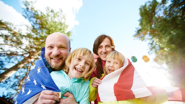 American family wrapped in flag