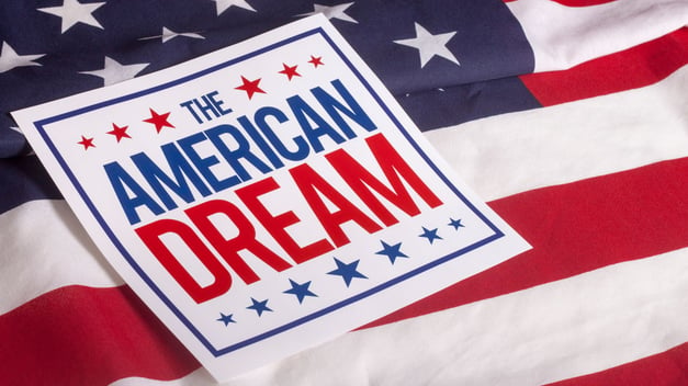 And American flag with a sign saying the American Dream