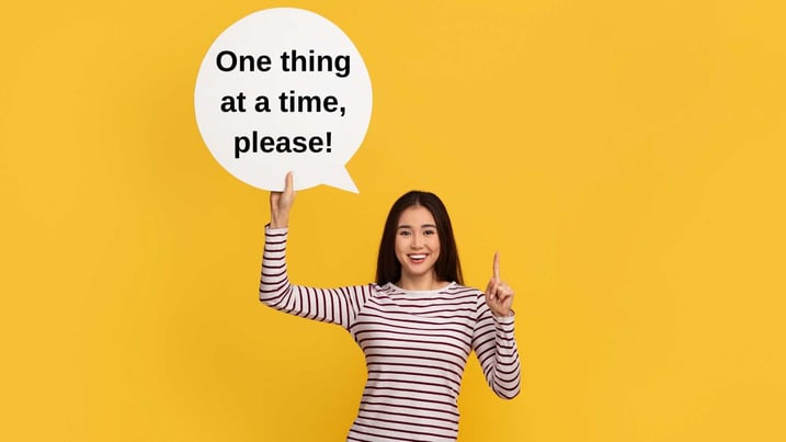 Asian girl holding a speech bubble