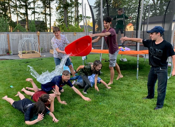 teen dumps water on laughing kids