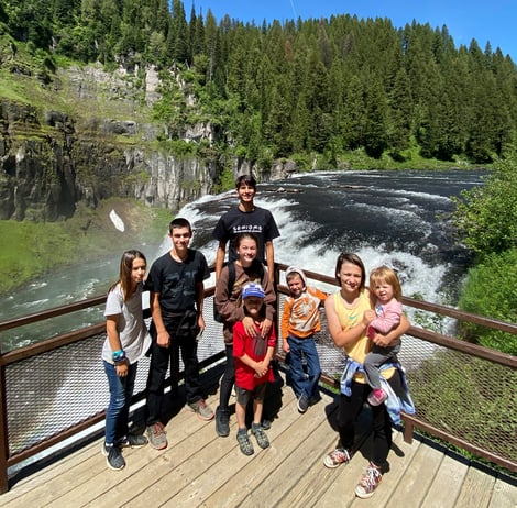 family in front of waterfall