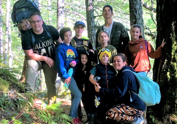 large family hiking in forest