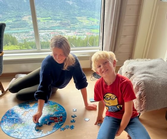 teen girl and young boy doing a puzzle