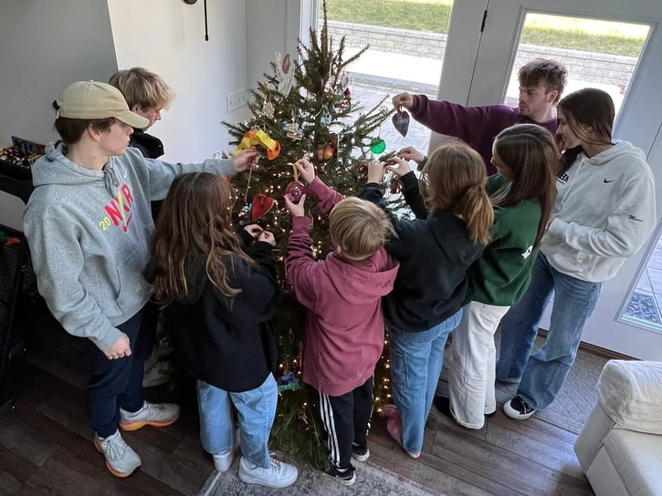 family decorating a Christmas tree