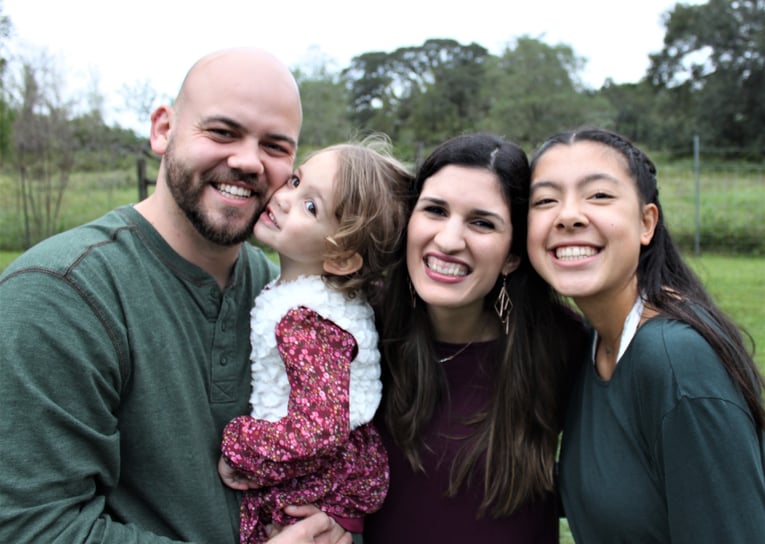 parents with small daughter and teenager exchange student from Germany