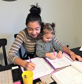 toddler doing homework with teen