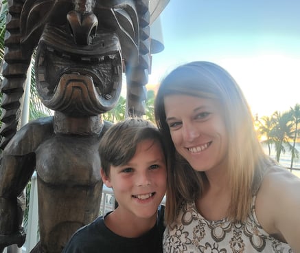 mother & son in front of totem pole