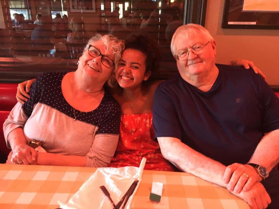 Older host mom and dad with teenage host daughter from Brazil