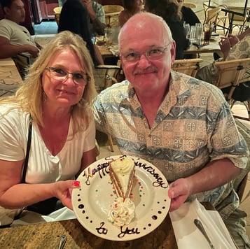 couple with anniversary cake