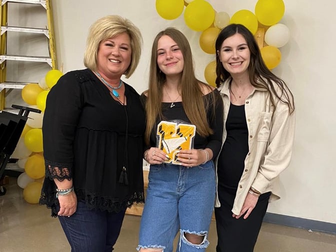 girl receiving high school letter