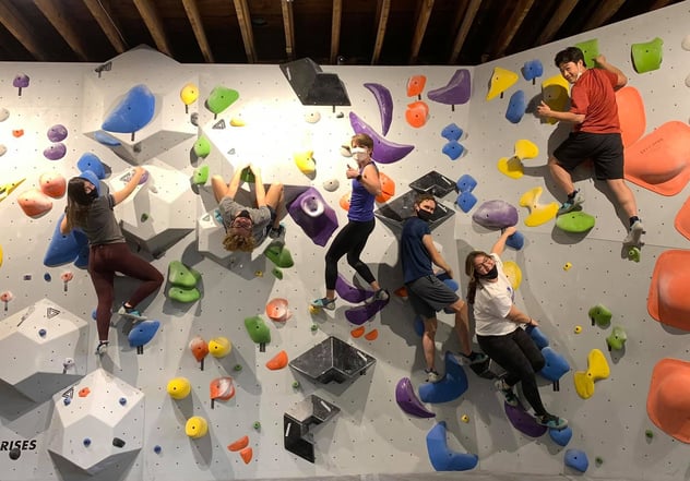 Chihok and 3 other teens on a colorful climbing wall