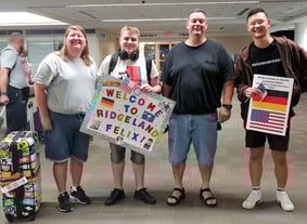 host family with new German exchange student at airport
