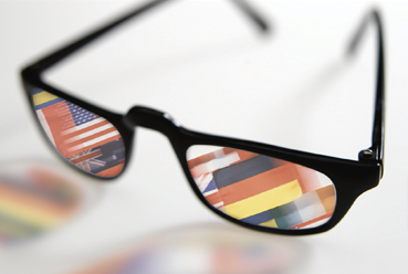 glasses with flags from around the world reflecting on the lenses