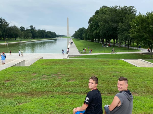 two boys in front of DC mall with Washington Monument in the background