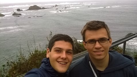 two teenage boys in front of the ocean