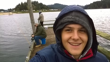 Dan on the dock with Bob fishing behind
