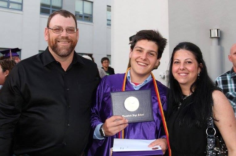 parents with son at high school graduation