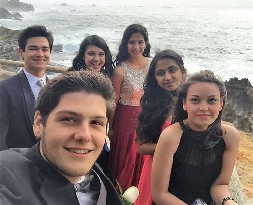 Dan with group of teens dressed up for prom