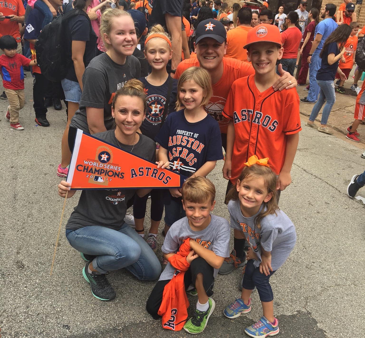 family huddled in Astros gear and pendant