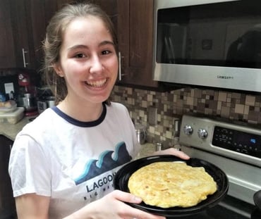 girl with cooked Spanish omelette