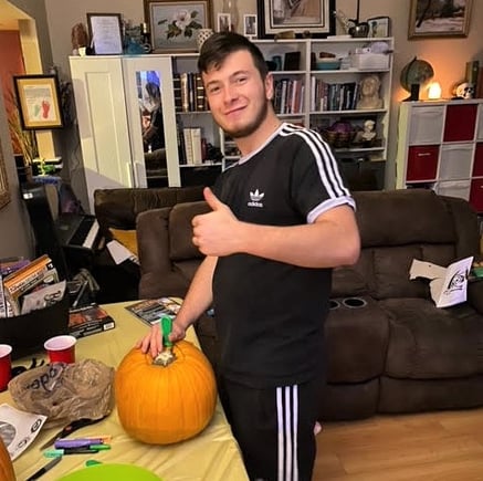 Ettore carving a Halloween pumpkin