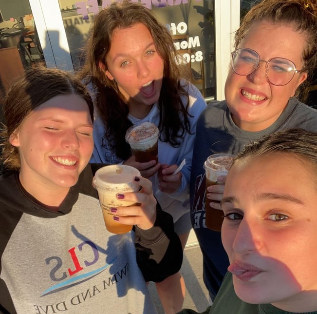 four teen girls drinking fall coffees