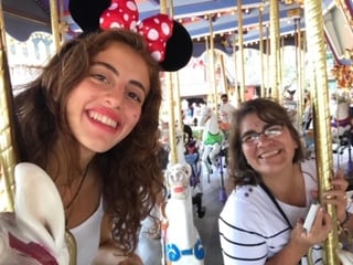 teen girl and host mother on carousel