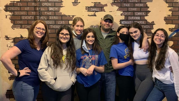 Family photo in front of brick wall