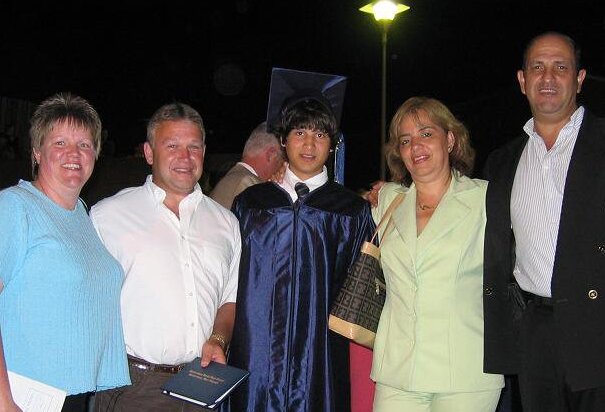 family photo with parents and son in graduation robe