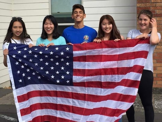 international exchange students with American flag