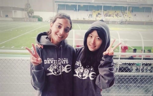 Korean exchange student and friend at football field