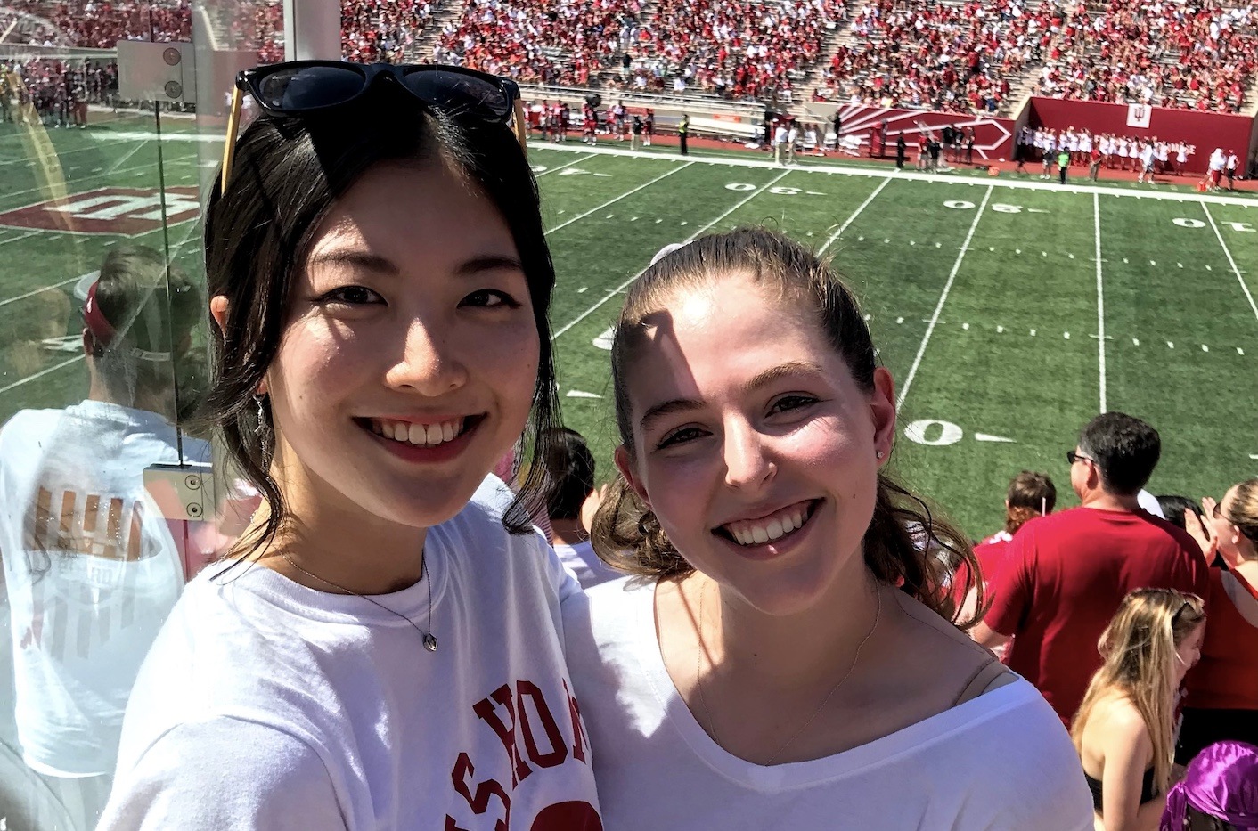 Female korean student and girlfriend at football game