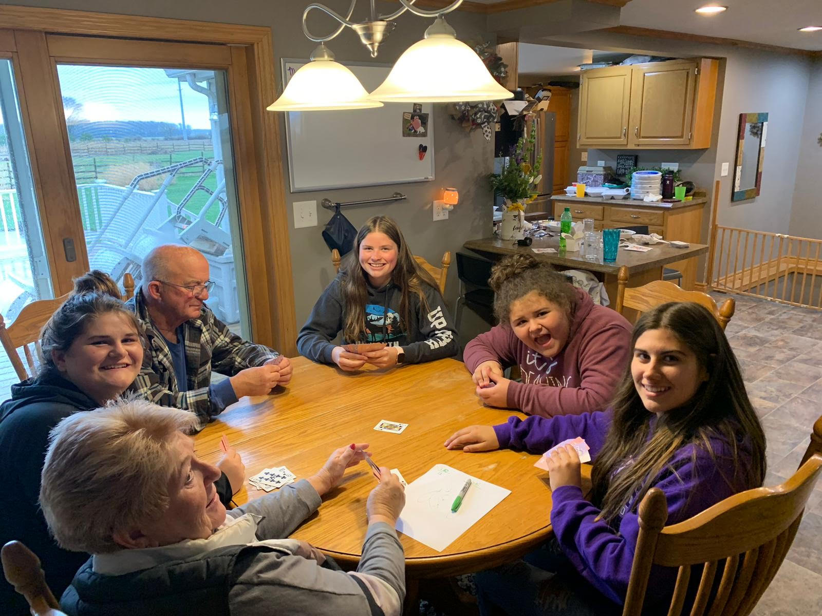 family playing cards around the table