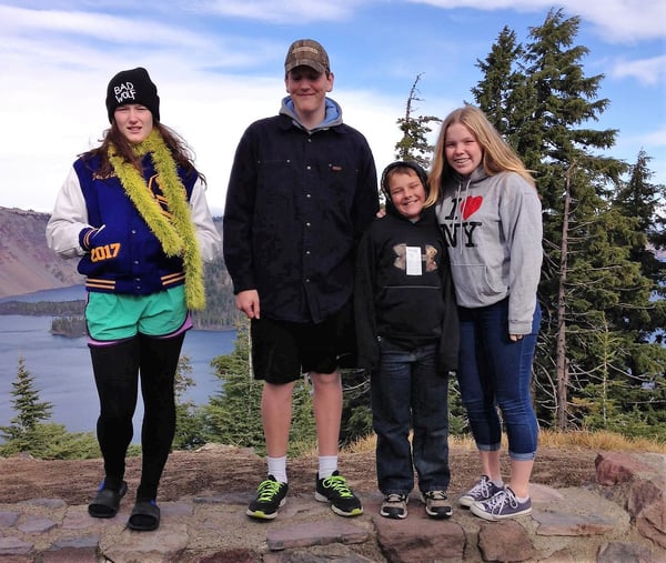 family standing in front of Crater Lake