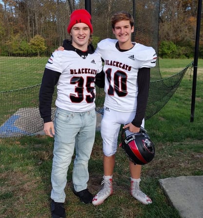 Jamie and host brother in football gear