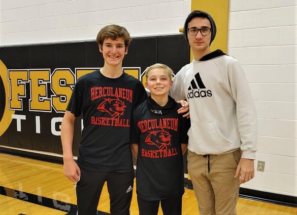 Jamie and two host brothers in the school gym