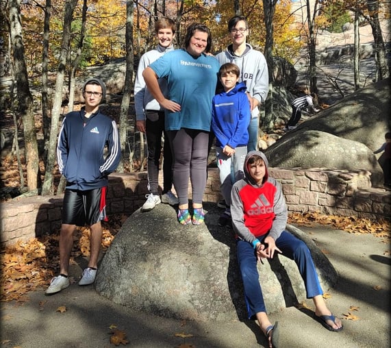 host mom and five boys in a park in the fall