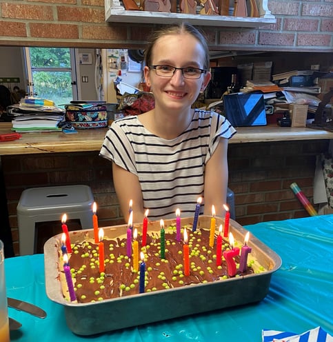 Jana smiling with birthday cake & candles