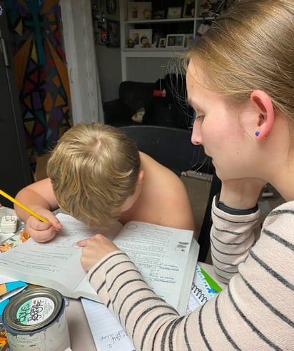Jana helping younger host brother with homework