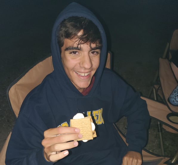 smiling boy eating s'mores