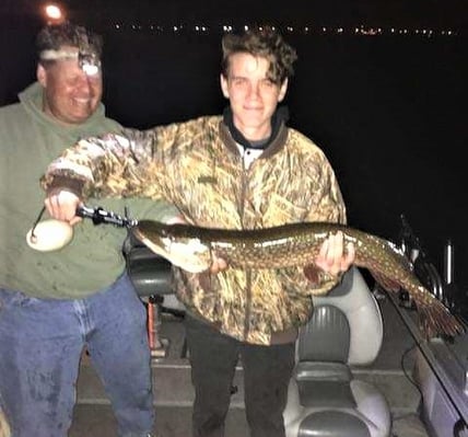 Dad with boy holding a big fish