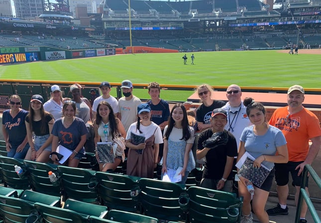 group of teens in a baseball stadium
