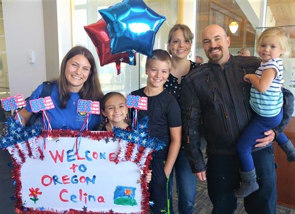 Family with young kids greeting exchange student