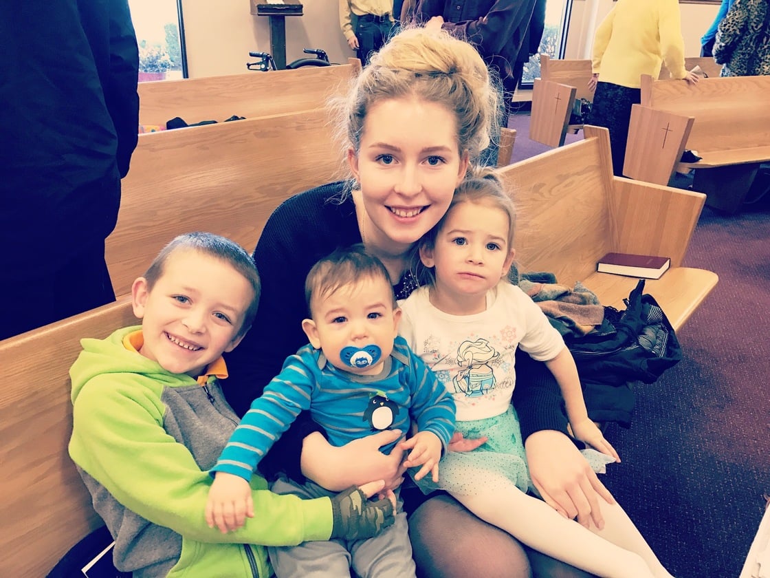 German exchange student at church with three small host siblings