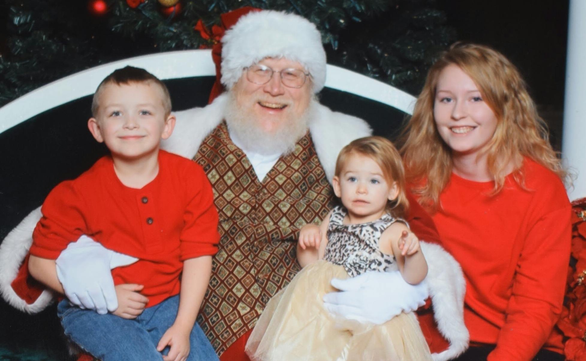 German exchange student and young host siblings with Santa Claus