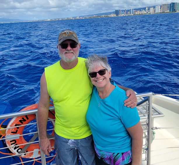 couple on a bot in the ocean